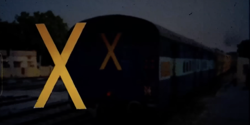 Yellow stripes on the side of an Indian railway coach, serving as indicators for reserved compartments designated for specific passenger classes, such as sleeper or general. These markings aid railway staff and passengers in easily identifying coach types, streamlining the boarding process.